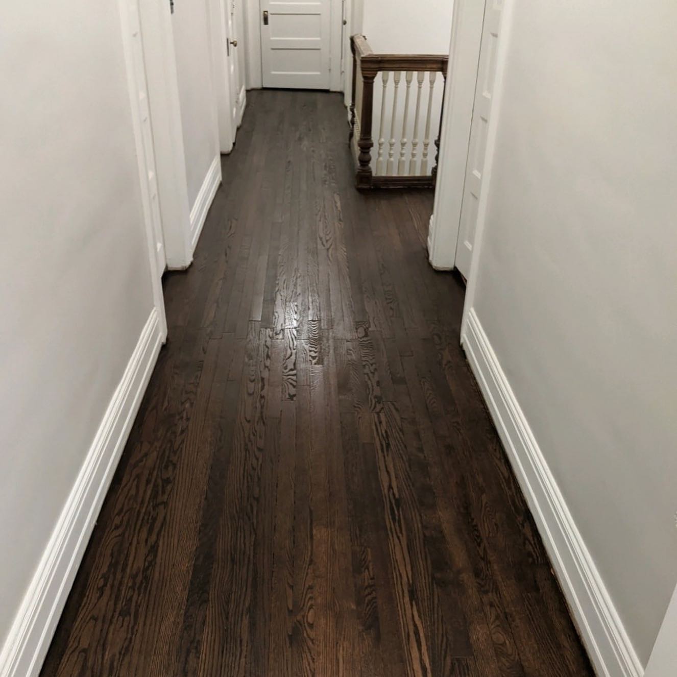 Dark stained hardwood flooring in hallway